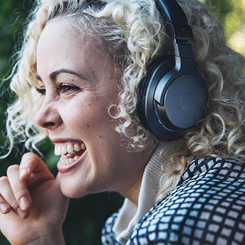 woman wearing headphones and smiling