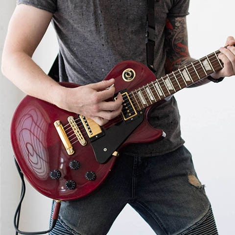 person playing electric guitar